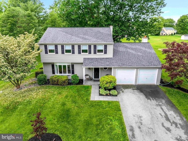 125 Christine Dr, Downingtown, PA 19335 - colonial-style house featuring an attached garage, a shingled roof, a chimney, driveway, and a front lawn