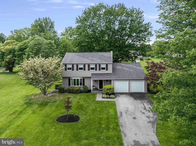 125 Christine Dr, Downingtown, PA 19335 - colonial house with a garage, driveway, a front lawn, roof with shingles, and a chimney