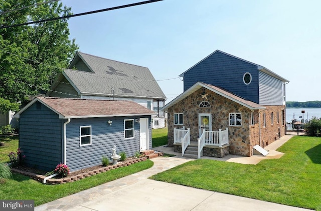 4534 Todd Pt, Sparrows Point, MD 21219 - view of front of house featuring a front lawn and roof with shingles