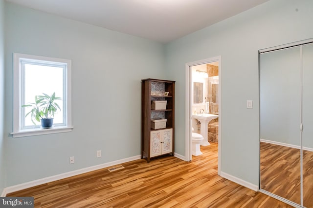 4534 Todd Pt, Sparrows Point, MD 21219 - unfurnished bedroom featuring light wood-style flooring, a closet, and ensuite bathroom