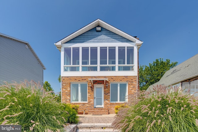 4534 Todd Pt, Sparrows Point, MD 21219 - view of front facade with a sunroom and brick siding