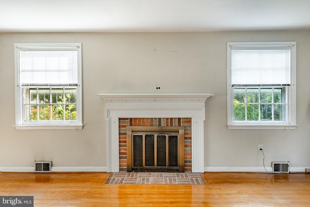 73 Duncan Ln, Springfield, PA 19064 - unfurnished living room featuring a brick fireplace and wood finished floors