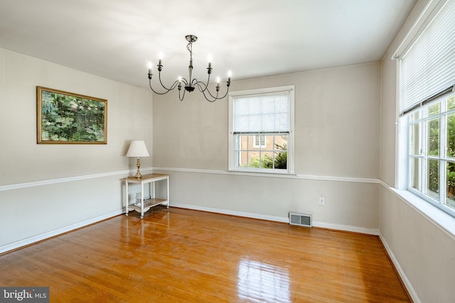 73 Duncan Ln, Springfield, PA 19064 - spare room featuring a chandelier and wood finished floors