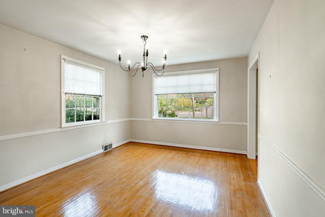 73 Duncan Ln, Springfield, PA 19064 - spare room with a chandelier, healthy amount of natural light, and wood finished floors