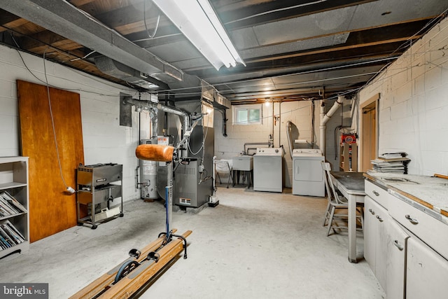 73 Duncan Ln, Springfield, PA 19064 - basement featuring independent washer and dryer, gas water heater, heating unit, and concrete block wall