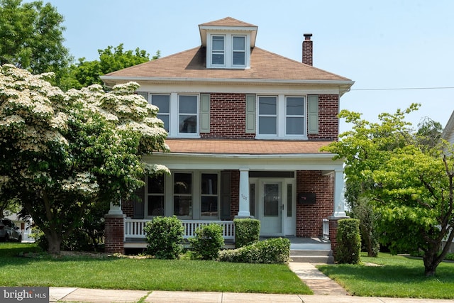 505 S Main St, Red Lion, PA 17356 - american foursquare style home featuring a porch, a chimney, brick siding, and a front lawn