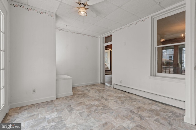 505 S Main St, Red Lion, PA 17356 - spare room featuring a baseboard heating unit, a ceiling fan, a paneled ceiling, and stone finish floors
