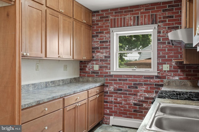 505 S Main St, Red Lion, PA 17356 - kitchen featuring ventilation hood, brick wall, light countertops, and baseboard heating