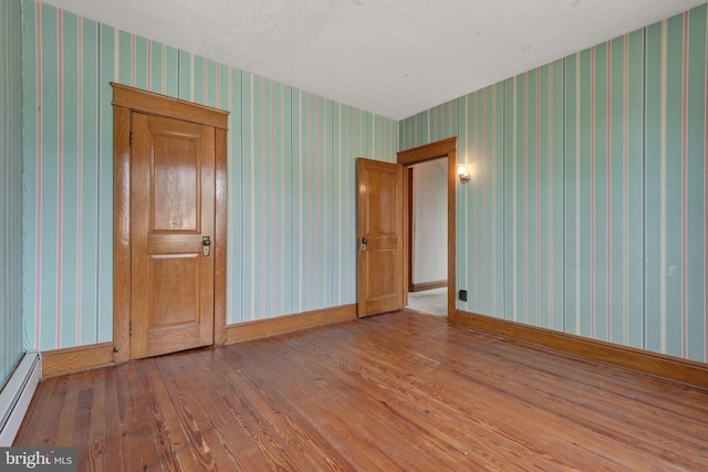 505 S Main St, Red Lion, PA 17356 - spare room featuring wallpapered walls, a baseboard heating unit, and hardwood / wood-style floors