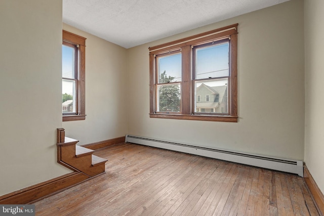 505 S Main St, Red Lion, PA 17356 - spare room with a baseboard heating unit, wood-type flooring, stairway, and a textured ceiling
