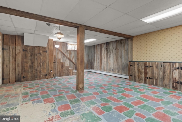 505 S Main St, Red Lion, PA 17356 - below grade area featuring wood walls, a baseboard heating unit, a drop ceiling, and stairs