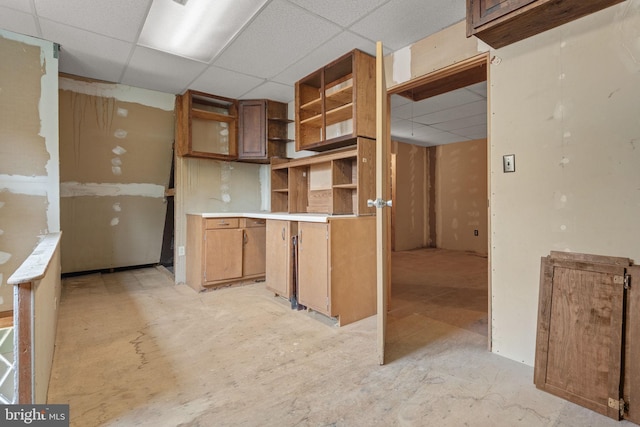 505 S Main St, Red Lion, PA 17356 - kitchen featuring a drop ceiling, open shelves, brown cabinetry, and light countertops