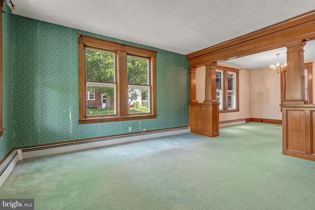 505 S Main St, Red Lion, PA 17356 - unfurnished room with a chandelier, carpet floors, wallpapered walls, a baseboard radiator, and ornate columns