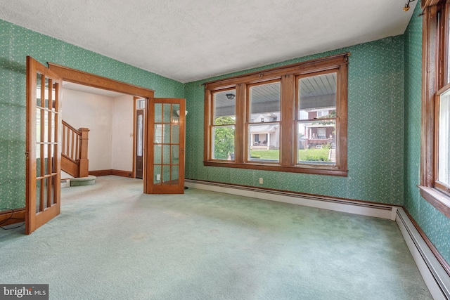 505 S Main St, Red Lion, PA 17356 - carpeted empty room with baseboard heating, wallpapered walls, plenty of natural light, stairs, and a textured ceiling
