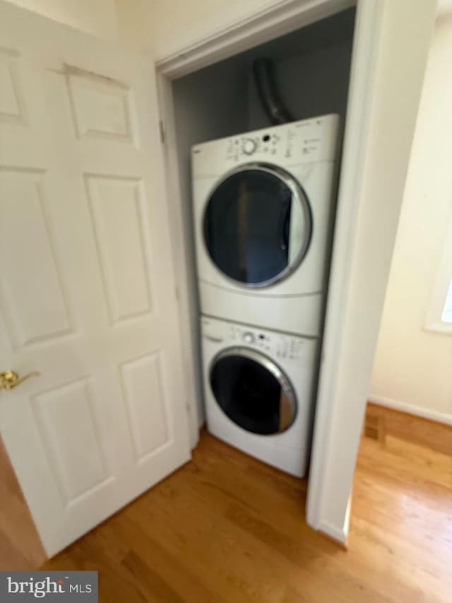 2133 Freda Dr, Vienna, VA 22181 - laundry area featuring stacked washer / dryer and light wood-type flooring