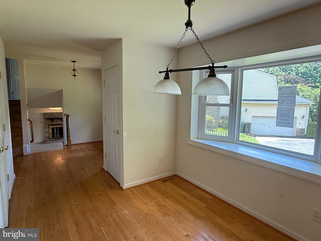 2133 Freda Dr, Vienna, VA 22181 - unfurnished dining area featuring light wood finished floors and a fireplace