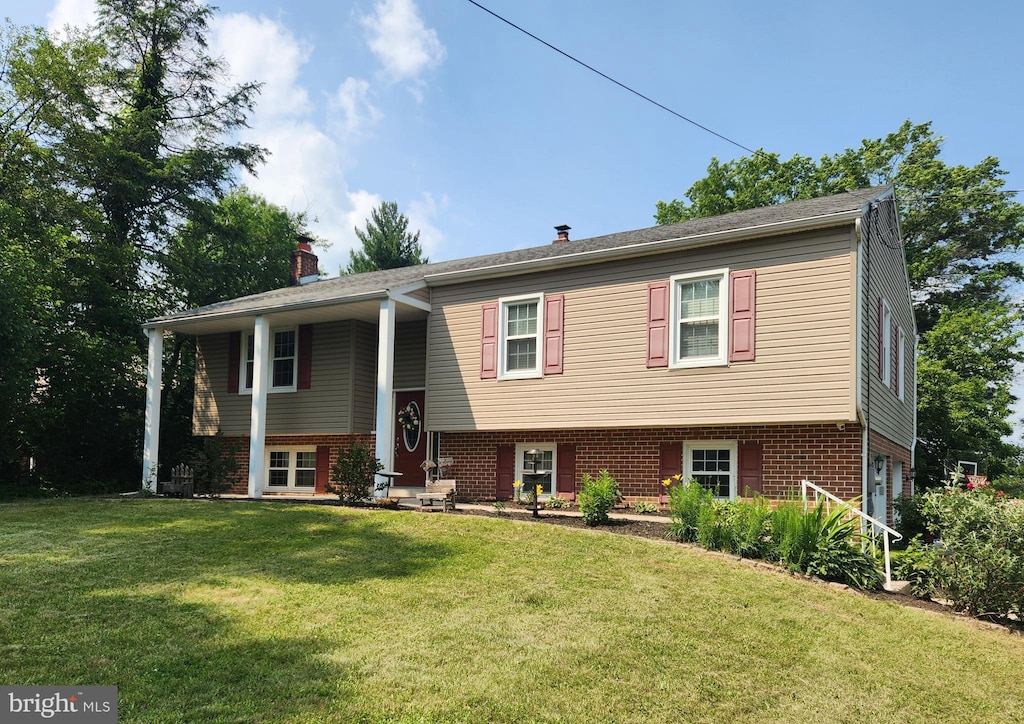 295 E Moyer Rd, Pottstown, PA 19464 - split foyer home with a front yard, brick siding, and a chimney