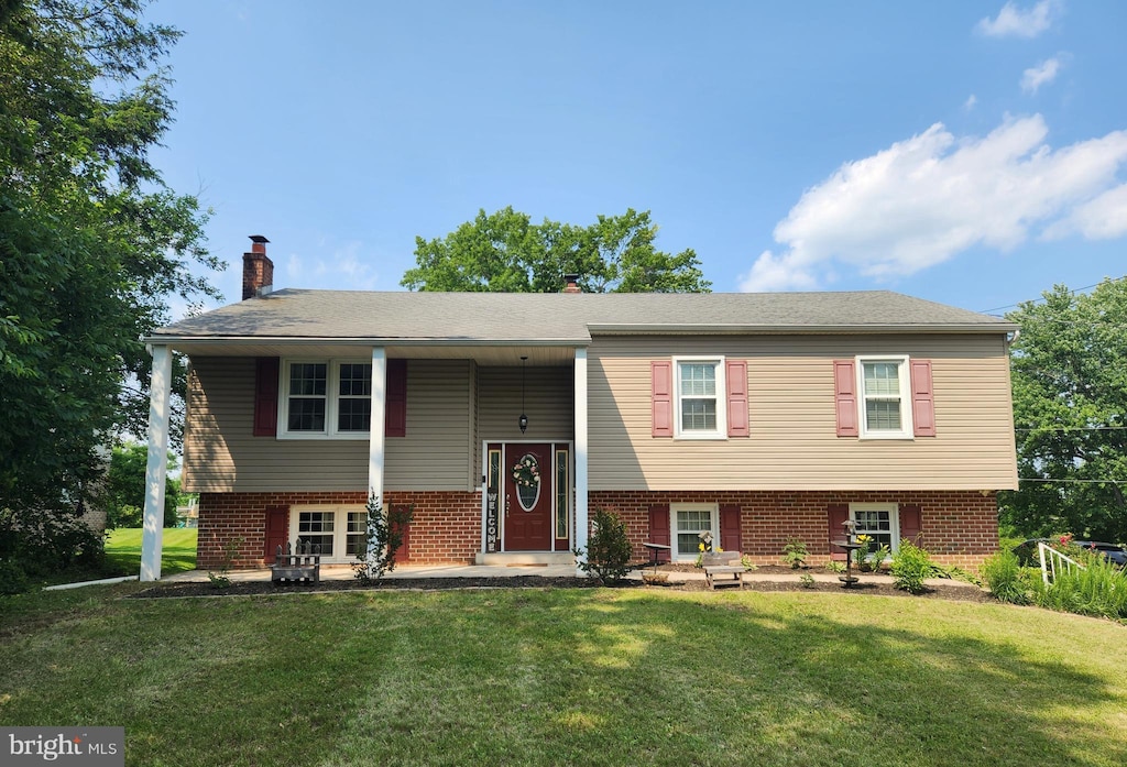 295 E Moyer Rd, Pottstown, PA 19464 - split foyer home with brick siding, a front lawn, and a chimney