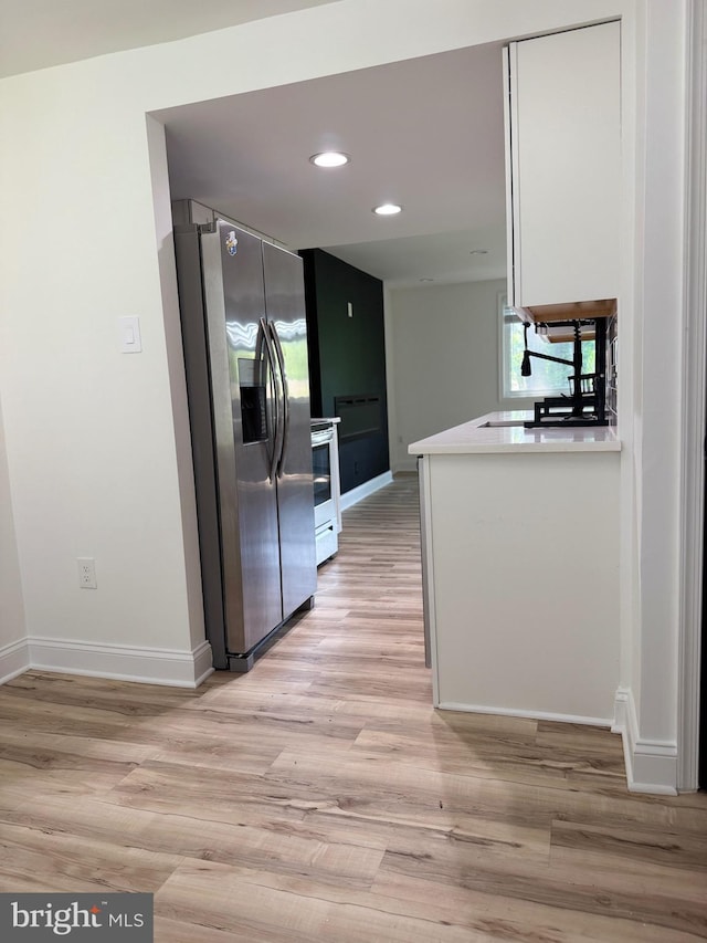 6529 Frietchie Row, Columbia, MD 21045 - kitchen with stainless steel appliances, light wood-type flooring, recessed lighting, light countertops, and white cabinets