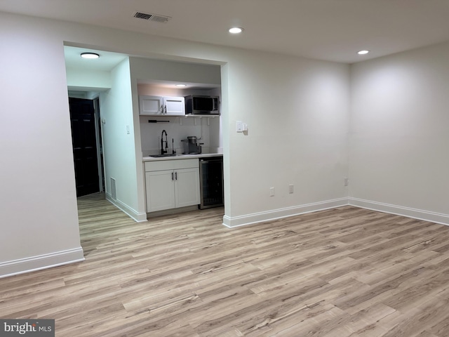 6529 Frietchie Row, Columbia, MD 21045 - indoor wet bar with wine cooler, light wood-style flooring, recessed lighting, and stainless steel microwave