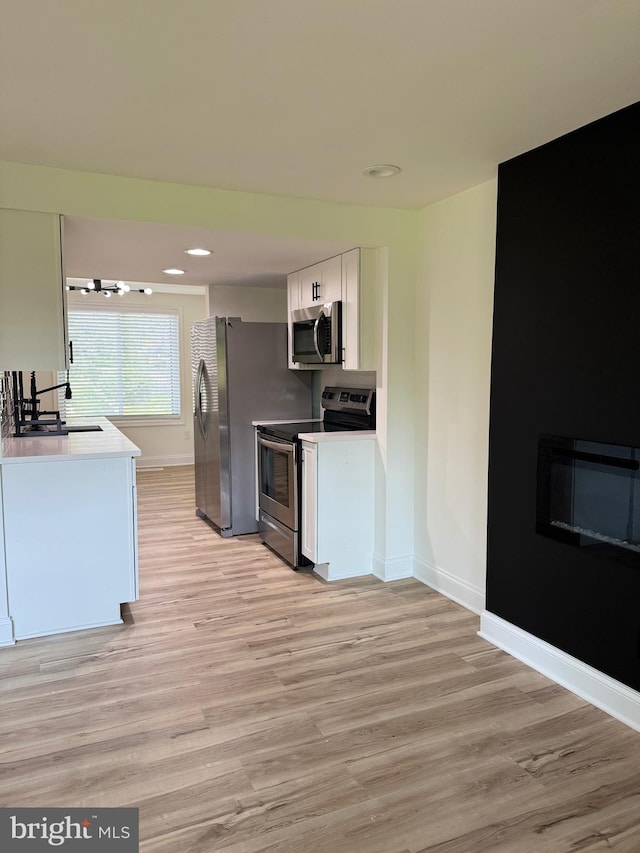 6529 Frietchie Row, Columbia, MD 21045 - kitchen with appliances with stainless steel finishes, light wood finished floors, white cabinetry, recessed lighting, and light countertops