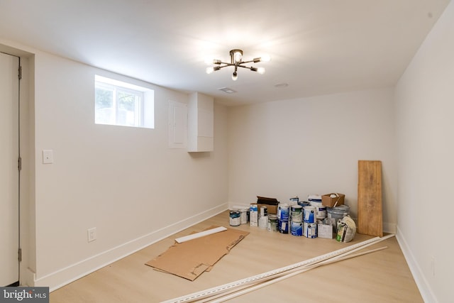 4802 Beaufort Ave, Baltimore, MD 21215 - below grade area with wood finished floors and a chandelier