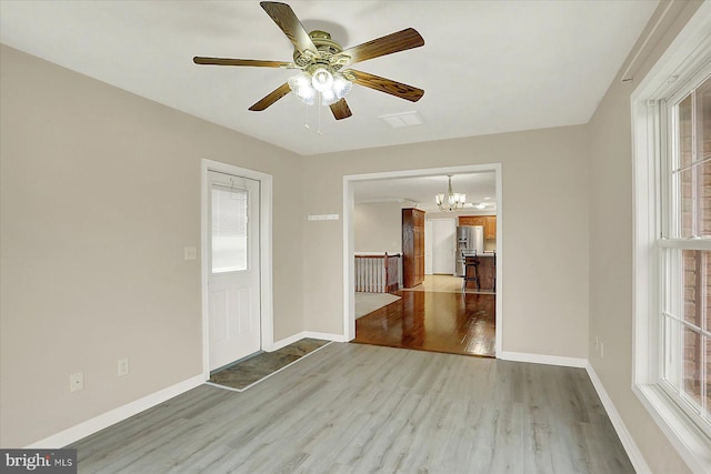 183 Mill Rd, Chambersburg, PA 17201 - unfurnished room featuring wood finished floors, a chandelier, and a ceiling fan