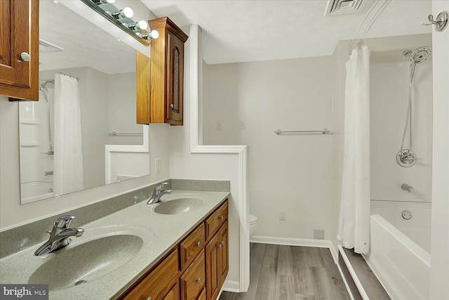 183 Mill Rd, Chambersburg, PA 17201 - bathroom featuring wood finished floors, double vanity, and shower / bath combo