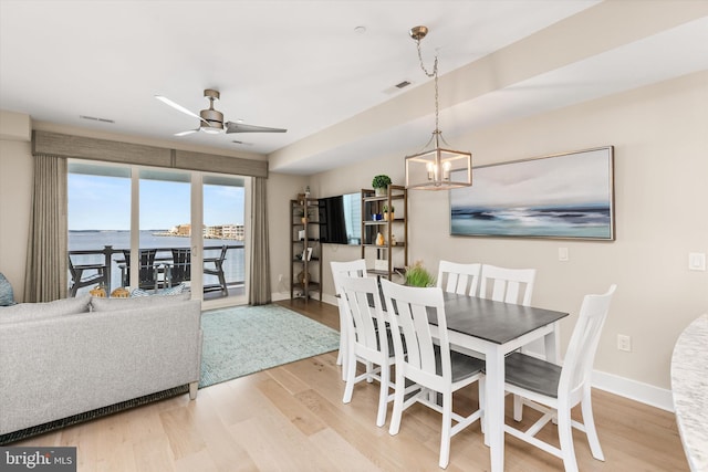 220 25th St Unit D, Ocean City, MD 21842 - dining area featuring ceiling fan, wood finished floors, and a chandelier