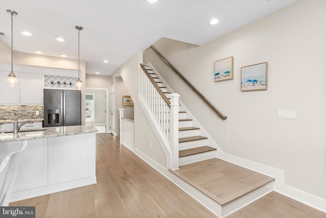 220 25th St Unit D, Ocean City, MD 21842 - staircase with wood finished floors and recessed lighting