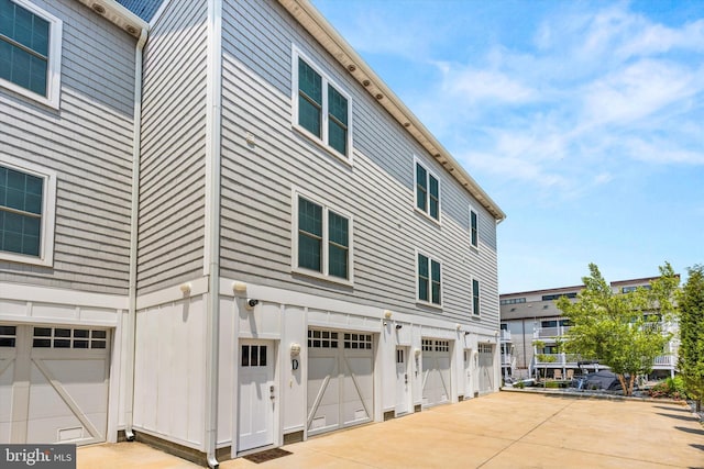 220 25th St Unit D, Ocean City, MD 21842 - view of property exterior with an attached garage and driveway