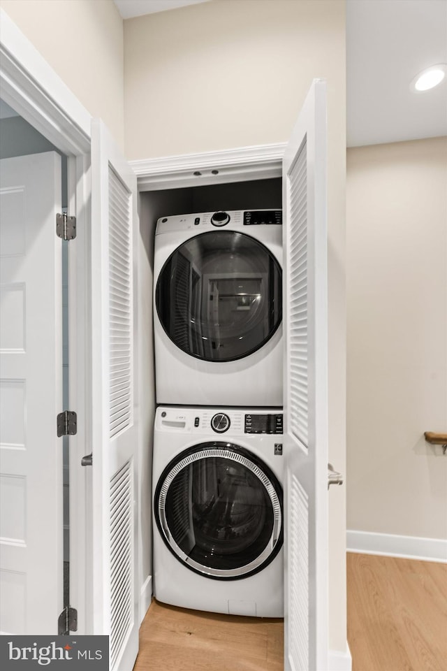 220 25th St Unit D, Ocean City, MD 21842 - laundry area with estacked washer and dryer and wood finished floors