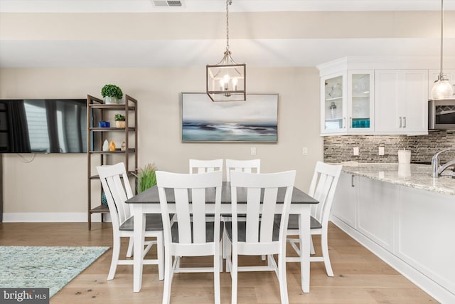220 25th St Unit D, Ocean City, MD 21842 - dining area with a chandelier and light wood finished floors