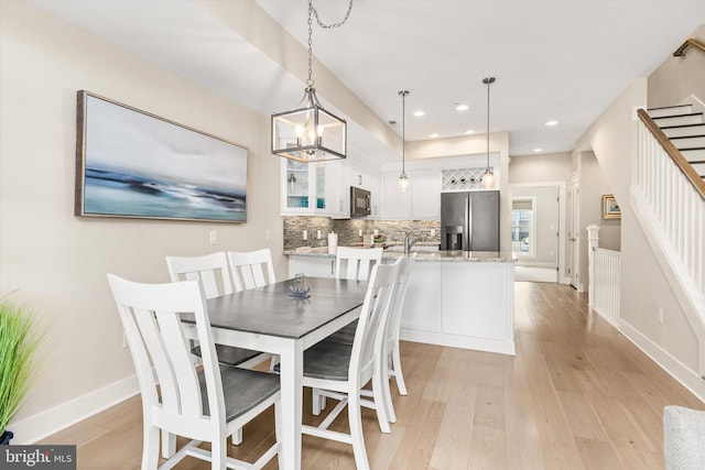 220 25th St Unit D, Ocean City, MD 21842 - dining space with light wood-style flooring, stairs, recessed lighting, and a chandelier