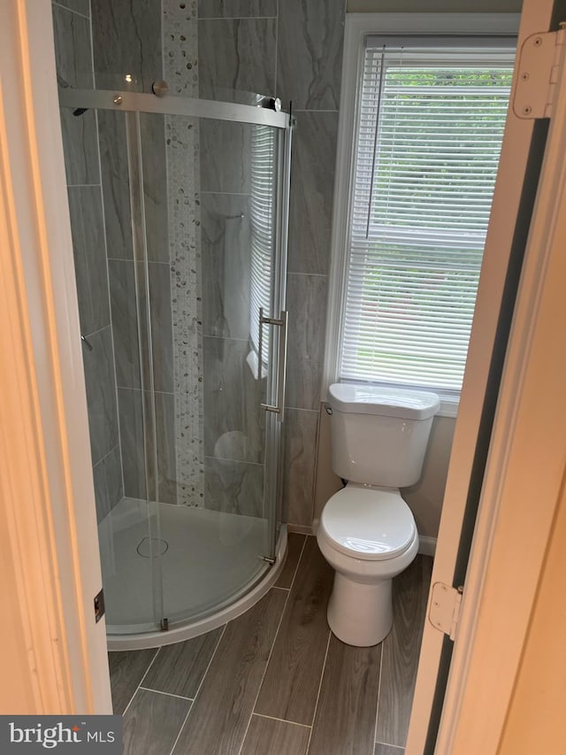 5511 Wesley Ave, Baltimore, MD 21207 - full bathroom featuring a shower stall and wood tiled floors