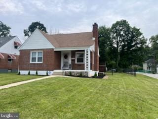 5511 Wesley Ave, Baltimore, MD 21207 - view of front of house with a front yard, a porch, and a chimney