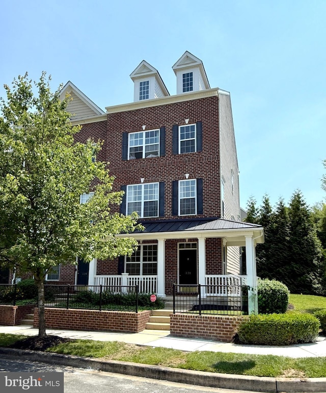 331 Lenape Way, Claymont, DE 19703 - view of front of house with covered porch, brick siding, and a standing seam roof