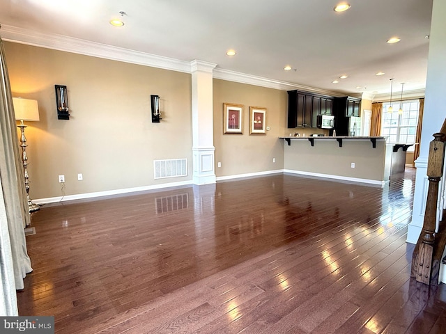 331 Lenape Way, Claymont, DE 19703 - unfurnished living room with ornate columns, crown molding, dark wood-style floors, and recessed lighting