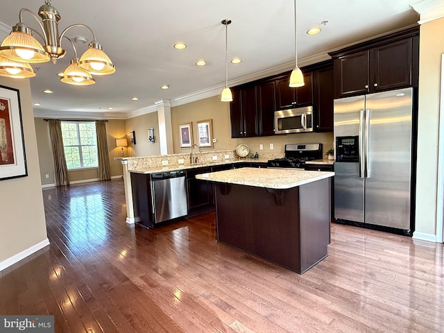 331 Lenape Way, Claymont, DE 19703 - kitchen with stainless steel appliances, ornamental molding, dark brown cabinets, a peninsula, and dark wood finished floors
