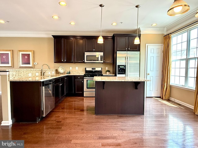 331 Lenape Way, Claymont, DE 19703 - kitchen with stainless steel appliances, crown molding, dark brown cabinetry, a kitchen bar, and wood finished floors