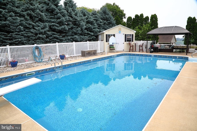 146 Skyline Dr, New Holland, PA 17557 - view of swimming pool featuring an outbuilding, a diving board, a patio, a storage structure, and outdoor lounge area