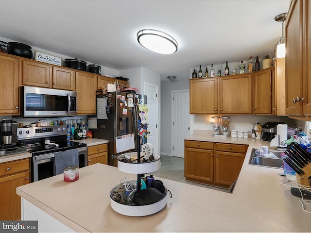 6 Thompson Ct, Boonsboro, MD 21713 - kitchen featuring stainless steel appliances, light countertops, a peninsula, and brown cabinets
