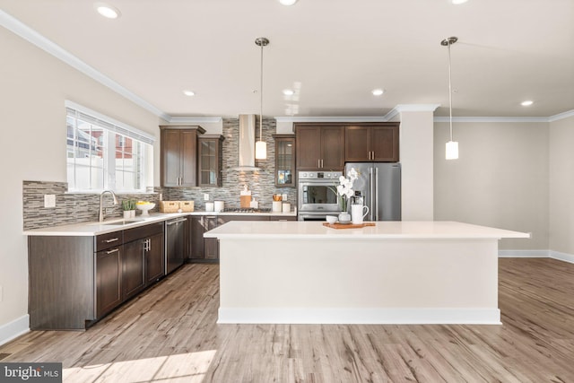 7955 Blue Stream Dr, Elkridge, MD 21075 - kitchen with appliances with stainless steel finishes, wall chimney exhaust hood, a center island, light countertops, and dark brown cabinetry