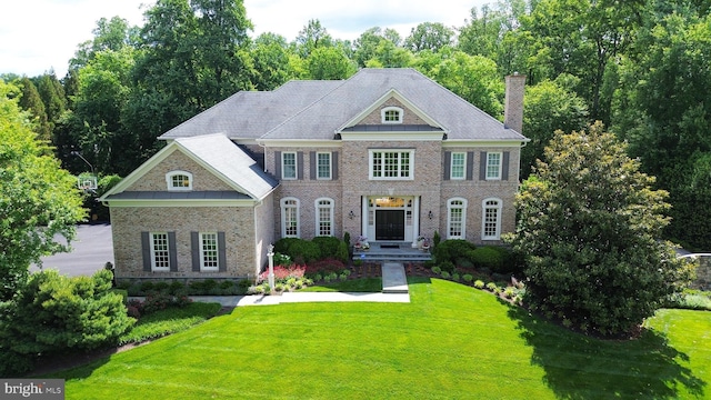 10757 Terkes Vw, Great Falls, VA 22066 - colonial home featuring brick siding, a front yard, and a chimney