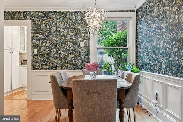636 N Alfred St, Alexandria, VA 22314 - dining space with wallpapered walls, light wood-style flooring, a wainscoted wall, ornamental molding, and a chandelier
