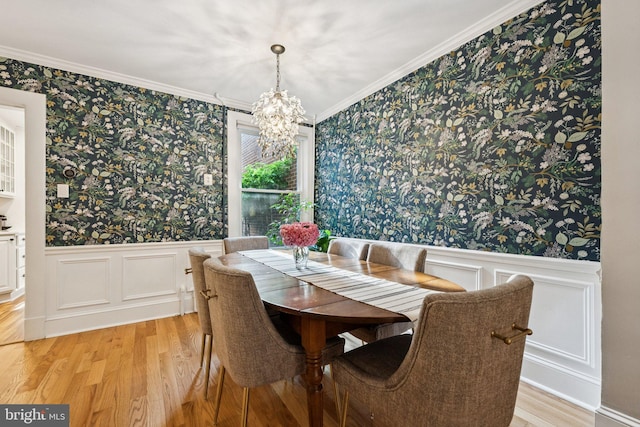 636 N Alfred St, Alexandria, VA 22314 - dining space featuring wallpapered walls, a chandelier, light wood-style flooring, a wainscoted wall, and ornamental molding