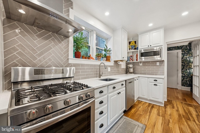 636 N Alfred St, Alexandria, VA 22314 - kitchen with stainless steel appliances, wall chimney range hood, decorative backsplash, white cabinets, and recessed lighting