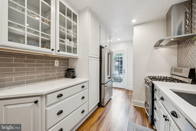 636 N Alfred St, Alexandria, VA 22314 - kitchen with island exhaust hood, appliances with stainless steel finishes, wood finished floors, backsplash, and recessed lighting