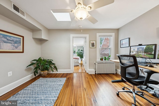 636 N Alfred St, Alexandria, VA 22314 - office area featuring ceiling fan, radiator heating unit, wood-type flooring, and a skylight
