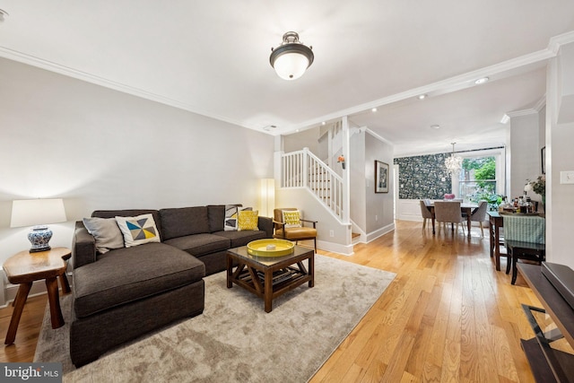636 N Alfred St, Alexandria, VA 22314 - living area featuring stairway, crown molding, light wood-style flooring, and a chandelier